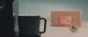 video of a coffee pouring into a mug, a woman has a sip and smiles, we see the coffee pod with its packaging